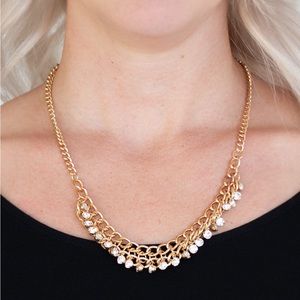 Golden and clear gem necklace with matching earrings.